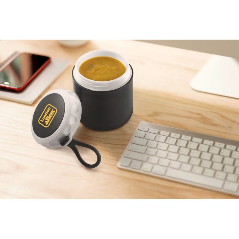 Soup in black container on desk