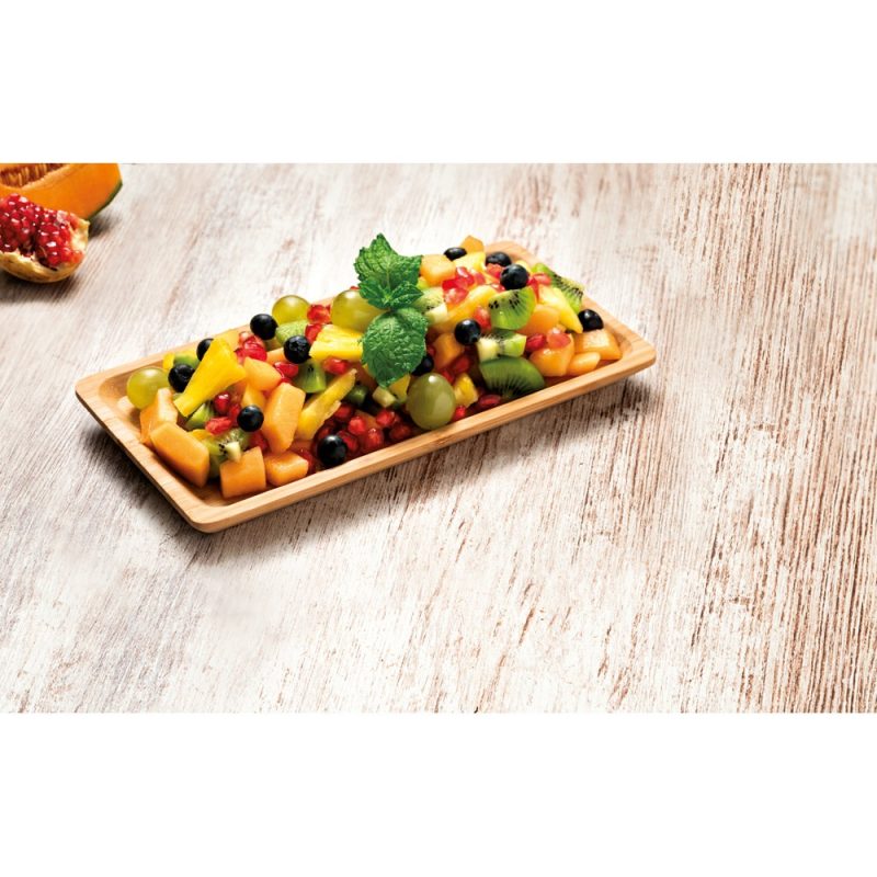 Colourful fruit salad on wooden platter