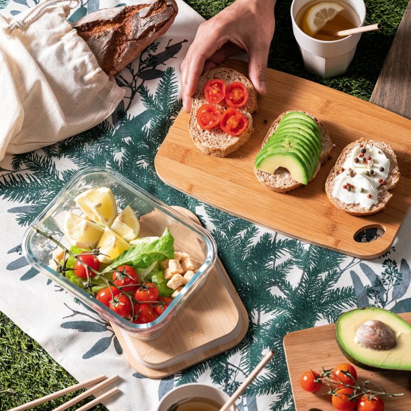 Healthy picnic with sandwiches, salad, and tea outdoors.