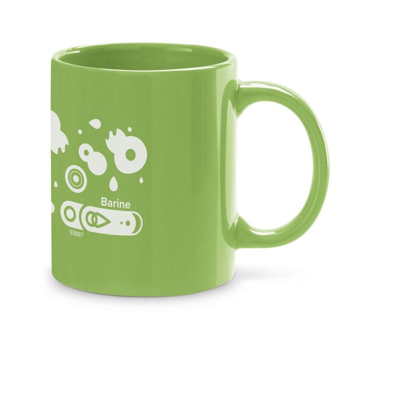 Green mug with white abstract design.