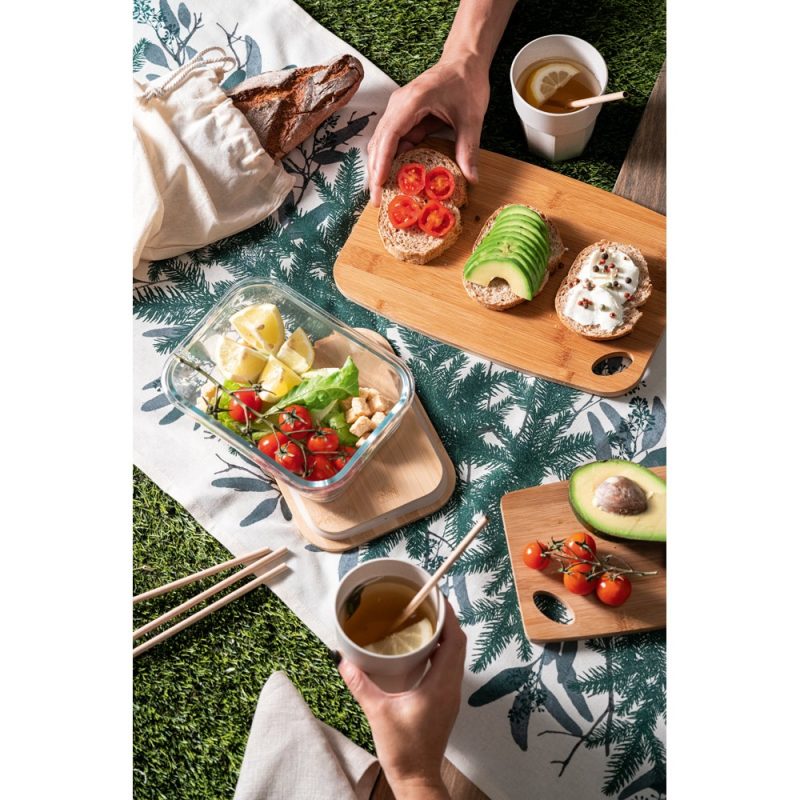 Outdoor picnic with avocado and tomato sandwiches.