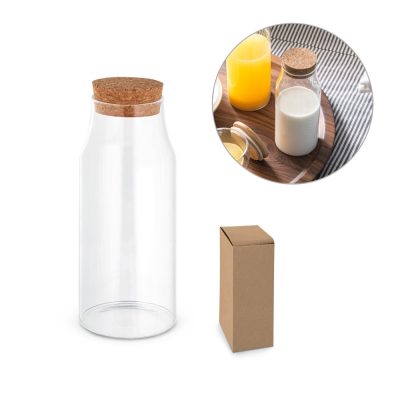 Glass bottle with cork next to cardboard box