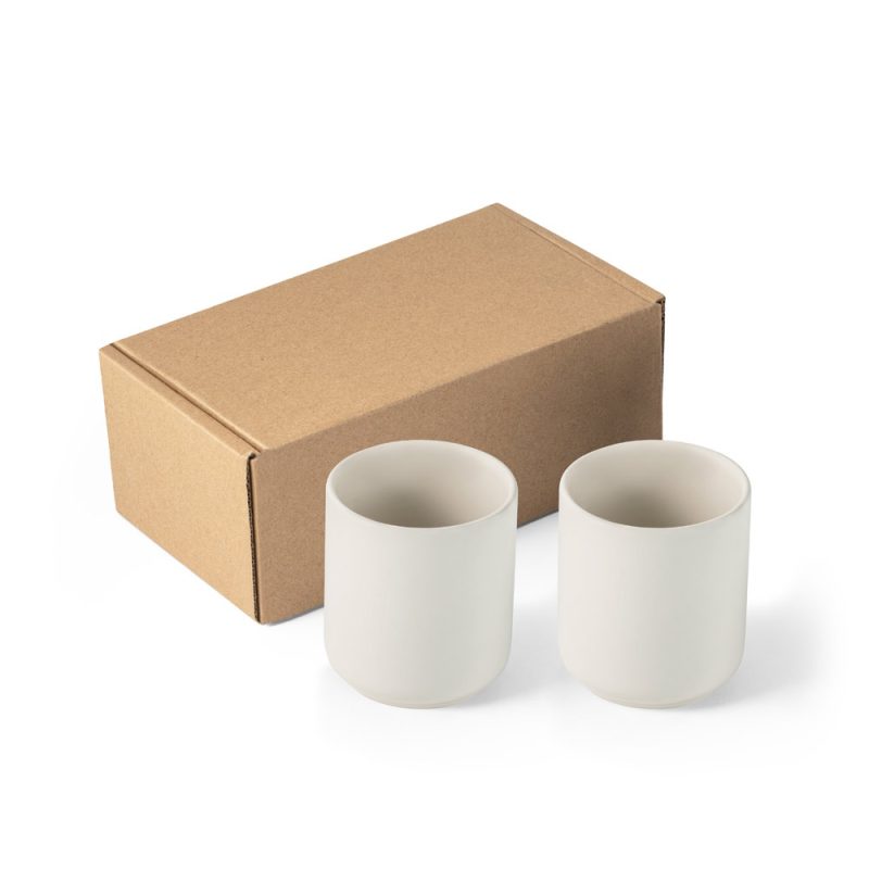 Two white mugs beside a cardboard box.