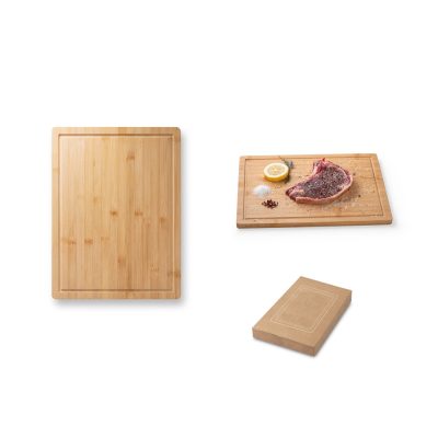 Bamboo chopping board with steak and seasoning.
