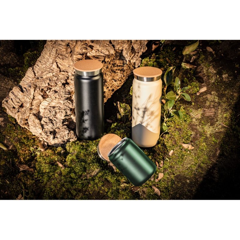 Three stylish cork-topped bottles on natural background.