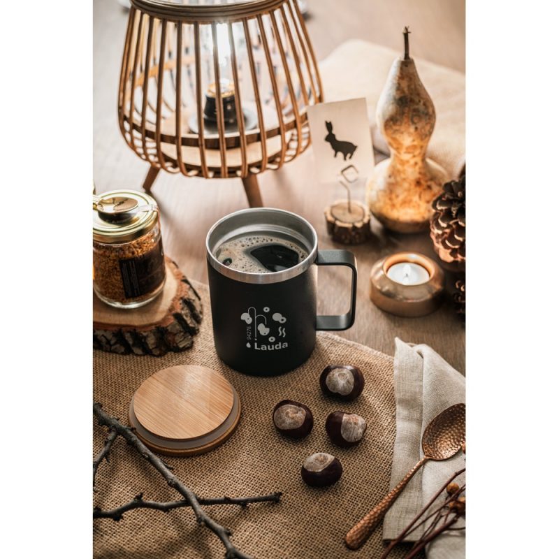 Cosy autumn-themed coffee setup with pumpkin and candle.