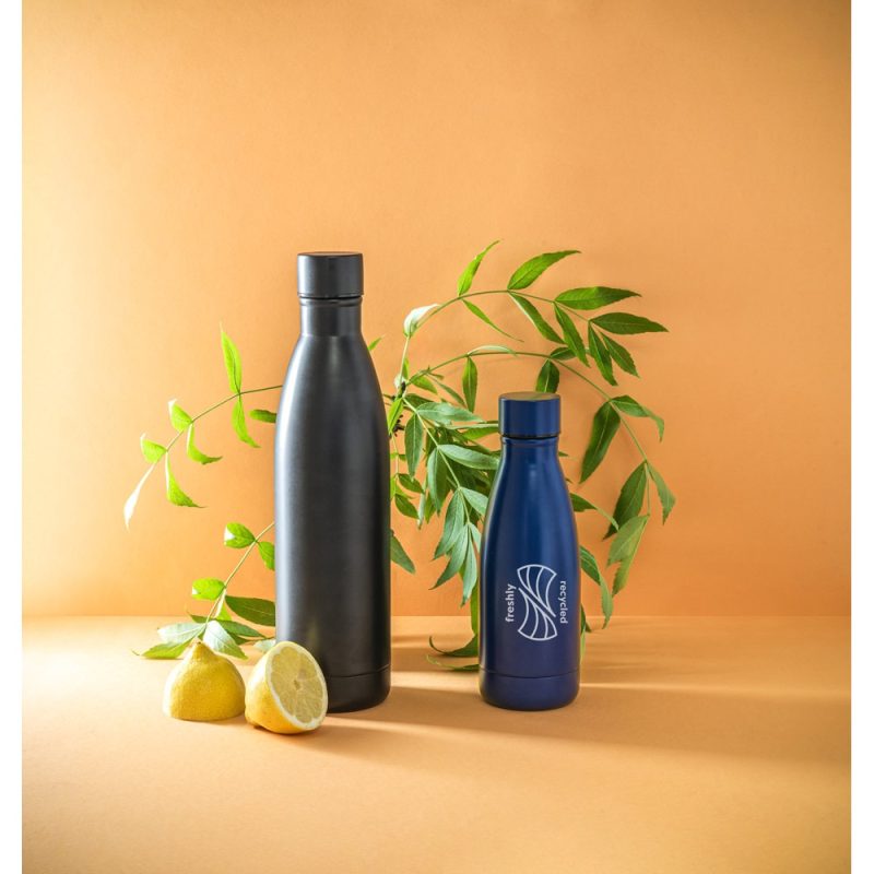 Eco-friendly bottles with lemons and leaves on orange background.