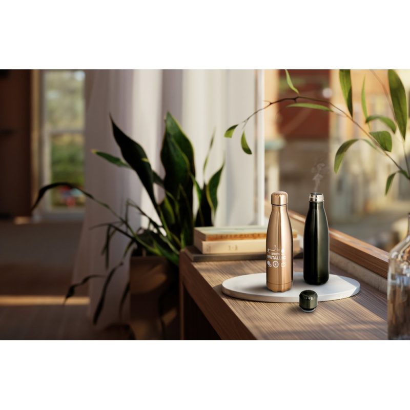 Stylish metal water bottles on wooden table.