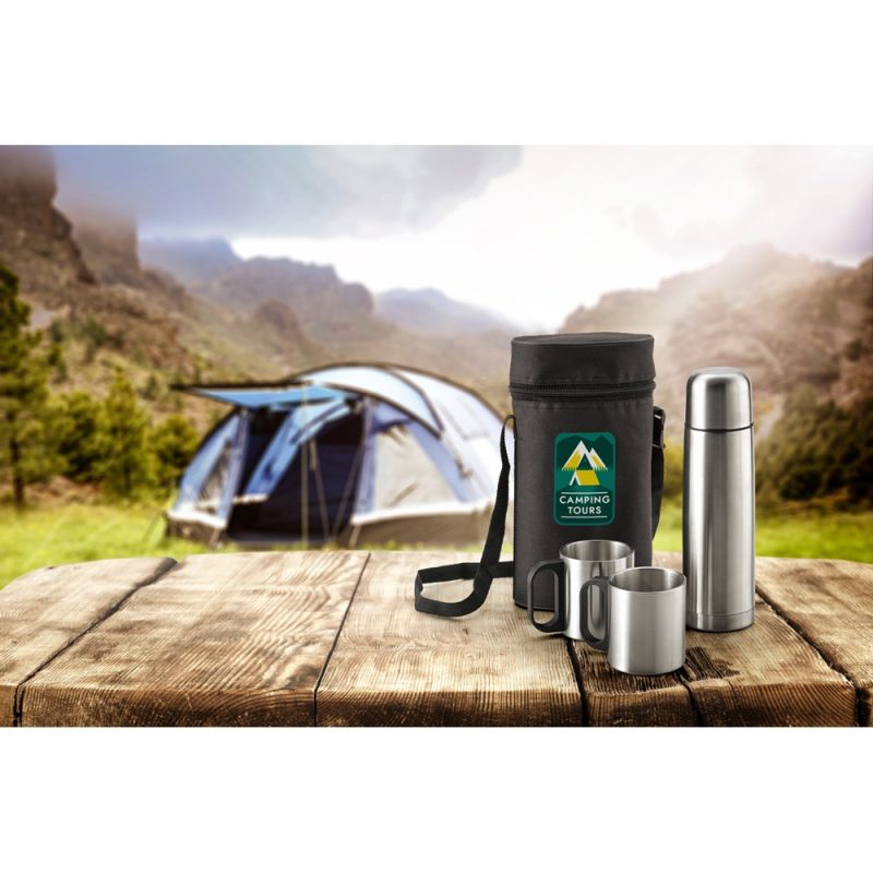Camping kit on a wooden table, tent in background.