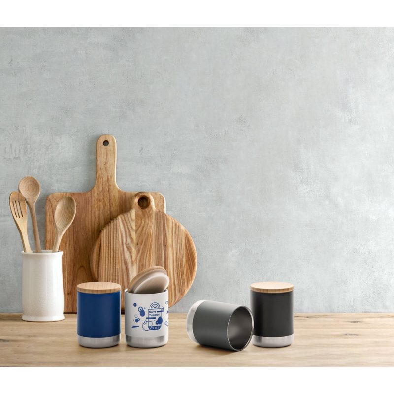 Wooden chopping boards, utensils, ceramic containers on kitchen counter.