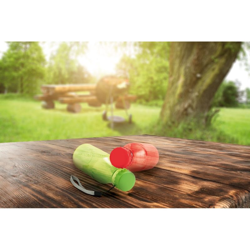 Coloured water bottles on wooden picnic table