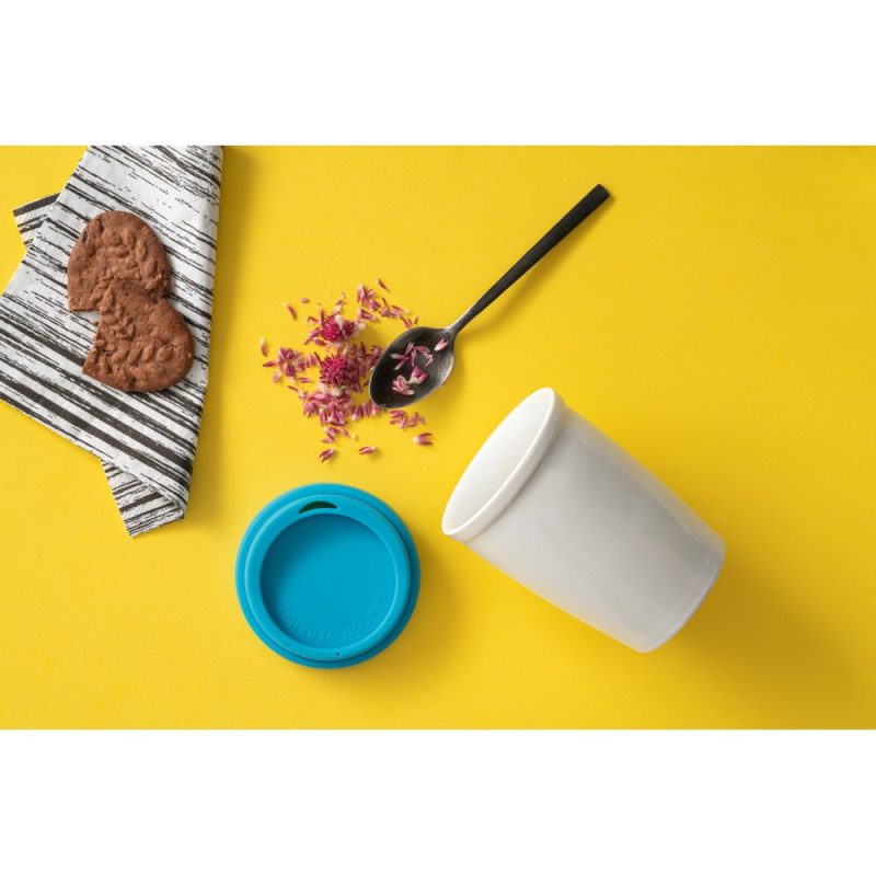 Reusable cup, cookies, petals on yellow background