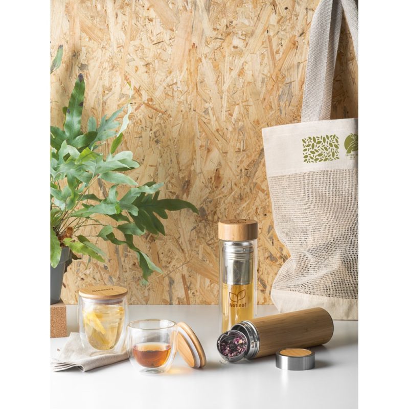 Eco-friendly tea infusers with tote bag on table.
