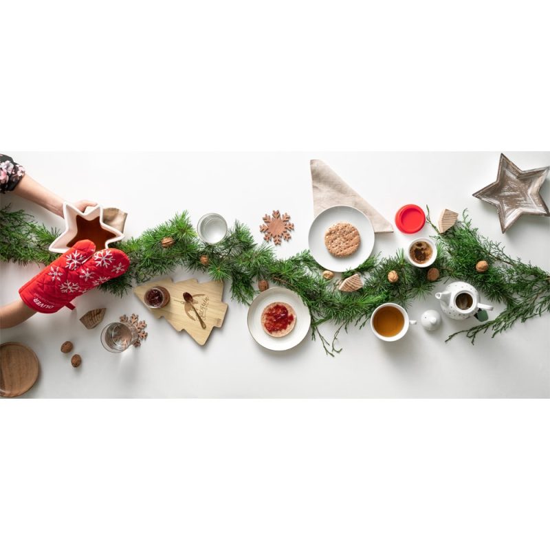 Festive table setting with cookies and greenery.
