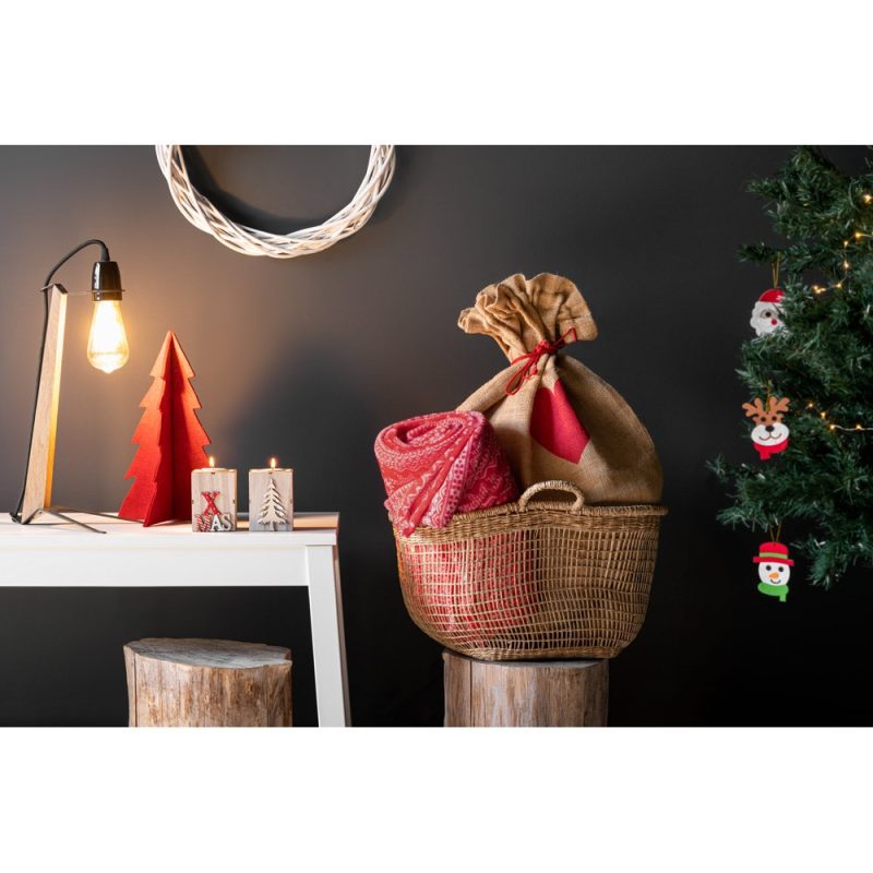 Cosy Christmas decor with lights, tree, gifts, and candles.