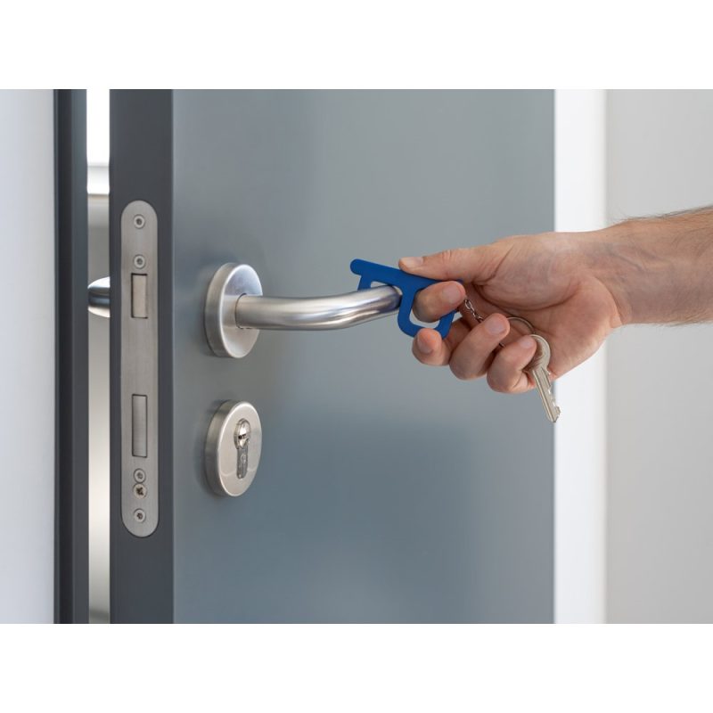 Using hygiene key tool on door handle.