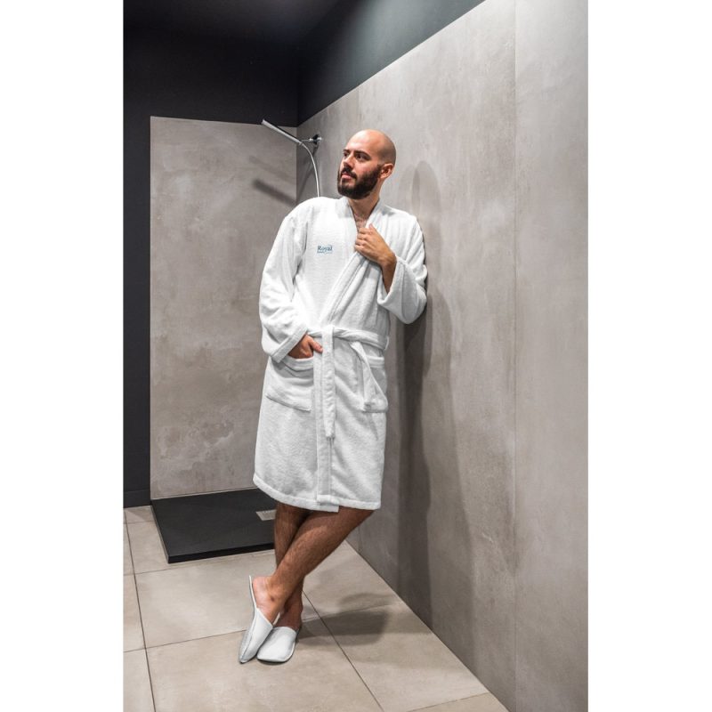 Man in white robe in modern bathroom