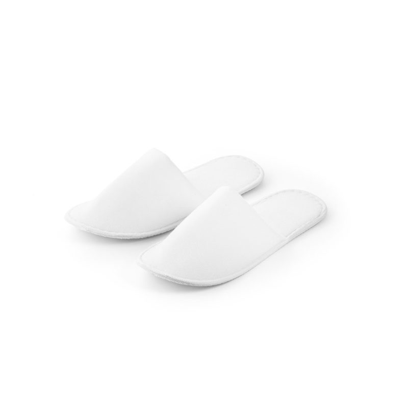 Pair of white hotel slippers on white background.