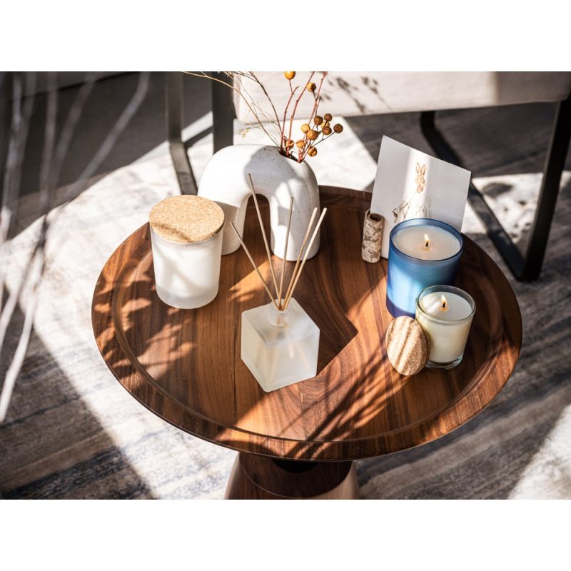 Wooden table with candles and decor items.