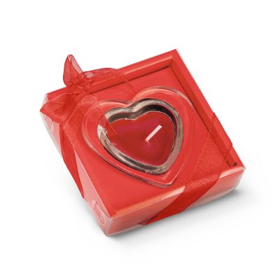 Heart-shaped red candle in a gift box.