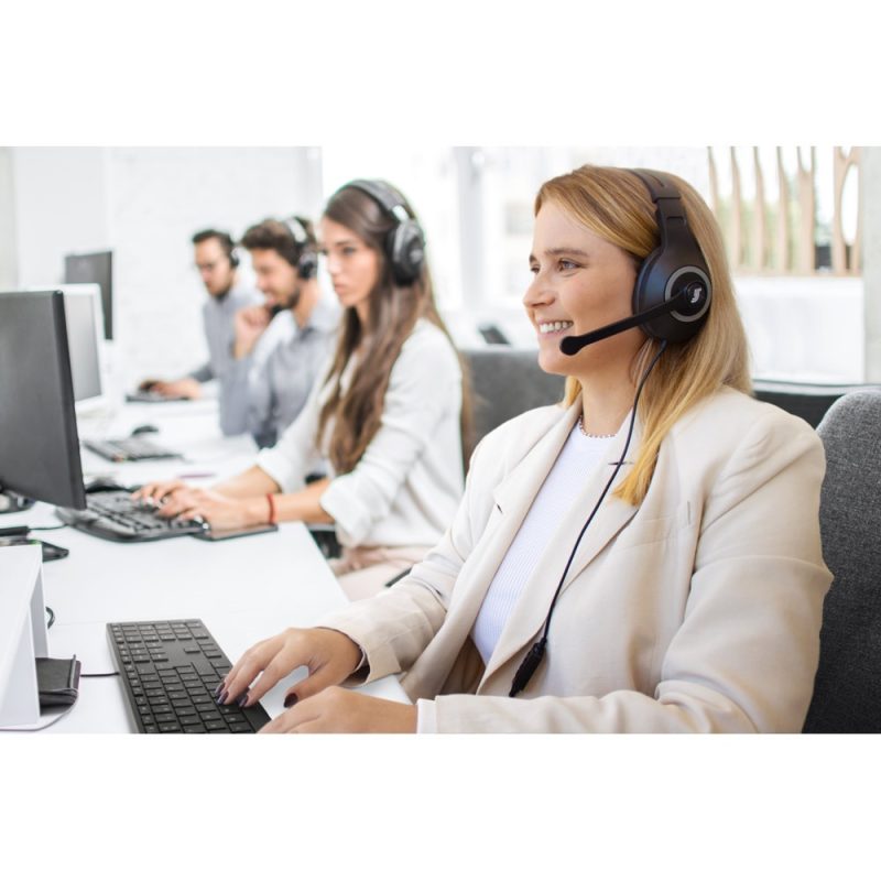 Customer service team using headsets in office environment.
