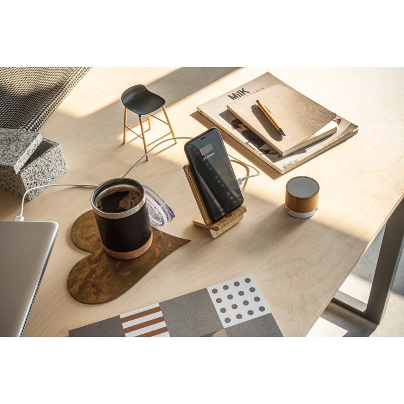 Modern office desk with tech and coffee cup.