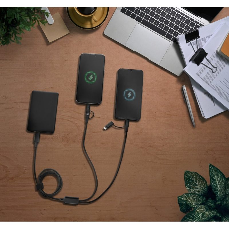 Power bank charging two smartphones on a desk.