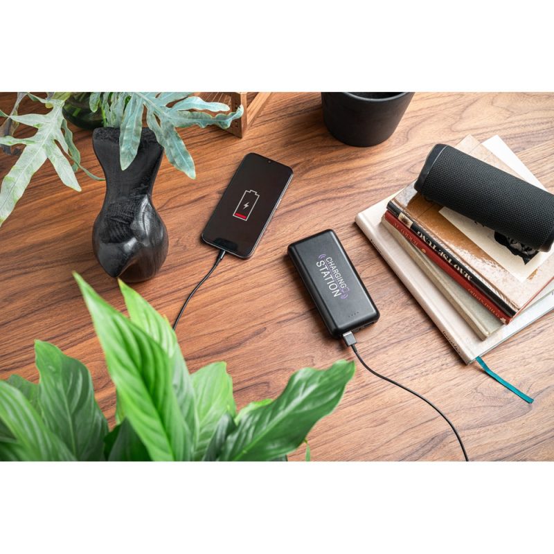 Phone charging on desk with power bank.