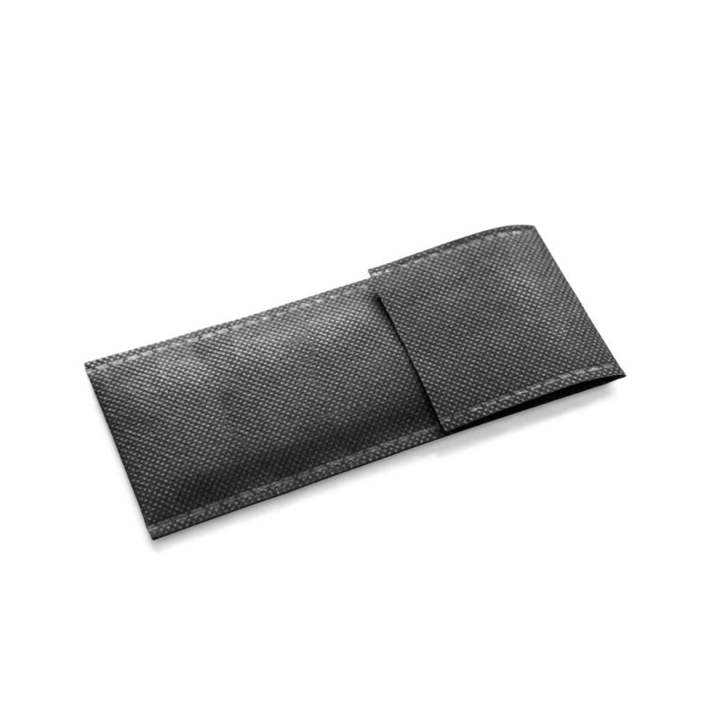 Folded black non-woven fabric bag on white background.