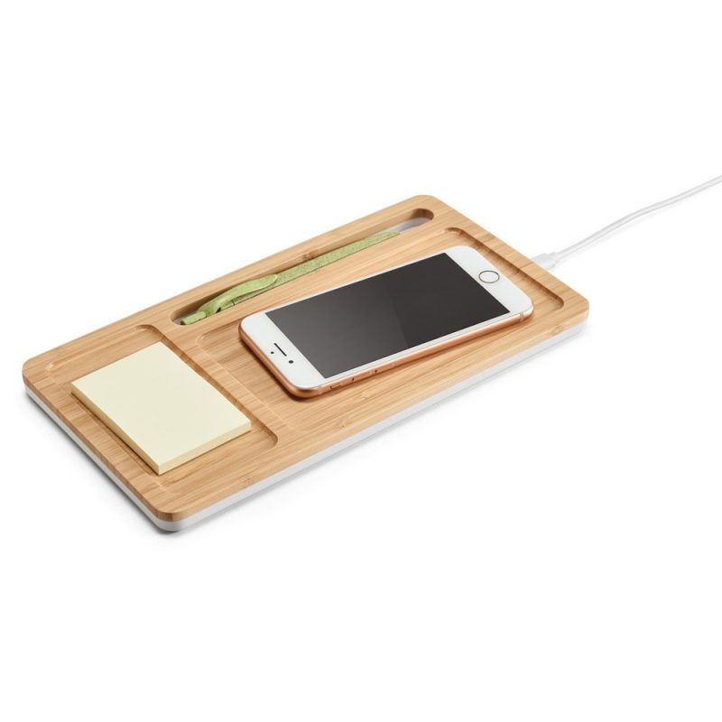 Wooden charging station with phone and notes.