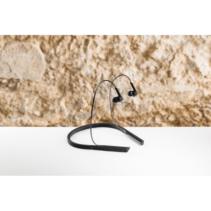 Black wireless earbuds on a white surface.