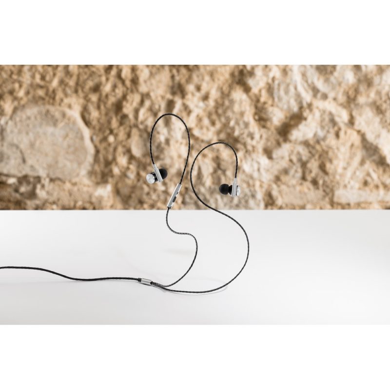 Black wired earphones on a white surface.