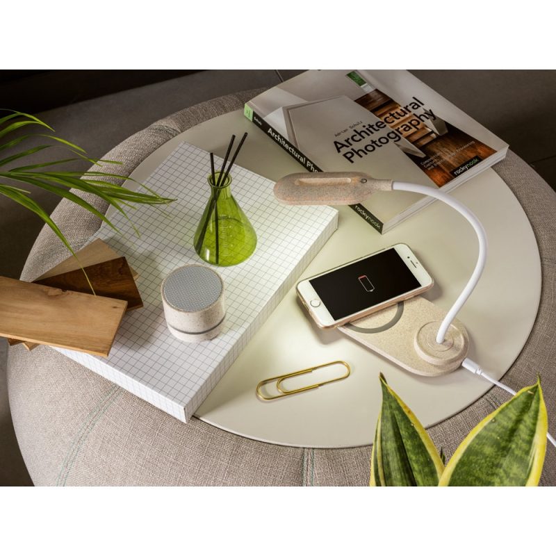 Modern desk setup with book and smartphone charging
