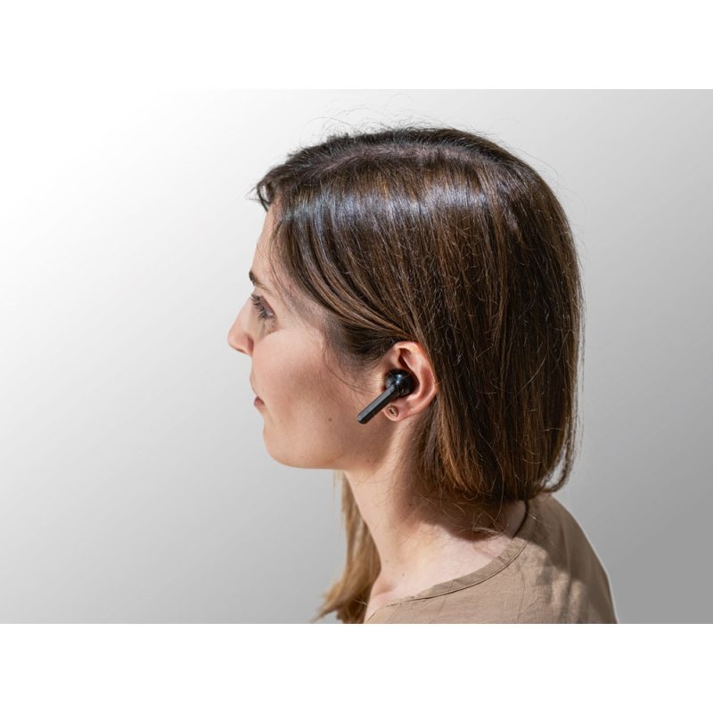 Person wearing black wireless earbud