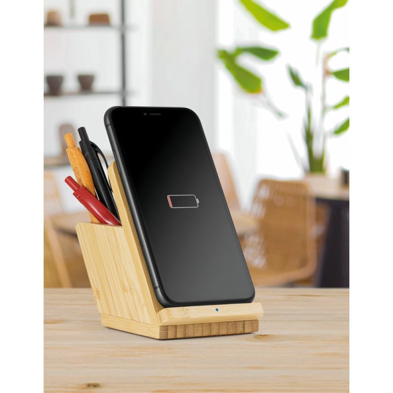 Mobile phone on bamboo stand, low battery alert.