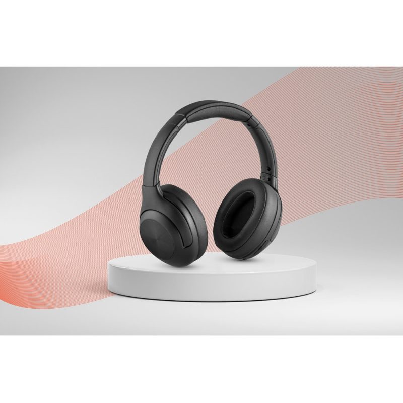 Black wireless headphones on a white stand.