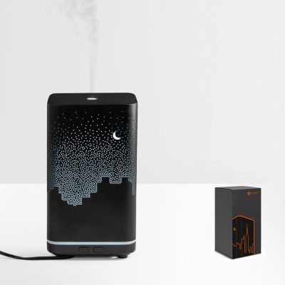 Stylish black humidifier emitting mist.