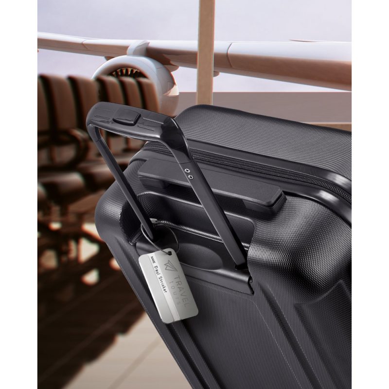 Suitcase with travel tag at airport gate